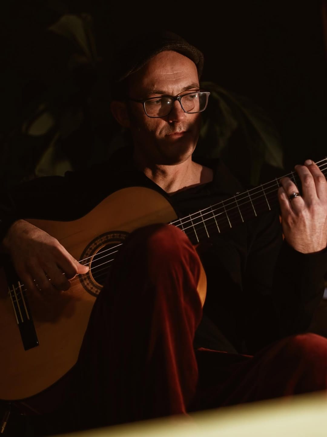 A guitarist playing live at an El Payo flamenco night.